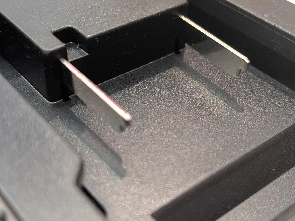 Ozito 18V PXC to RIDGID Plumbing battery adapter - close-up of the two battery-side terminal blades